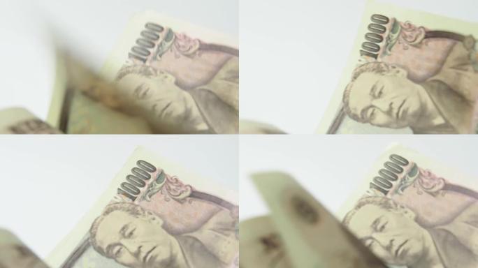 特写一张一张地翻转日本钞票。