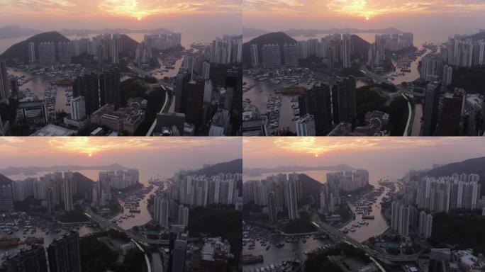香港空中v32在日落时飞越黄竹坑市区。