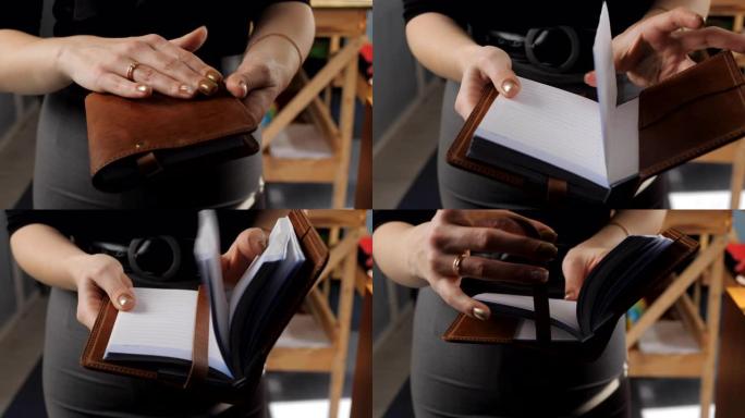 女人演示日记在棕色皮革封面手工制作，特写。