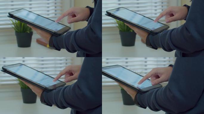 使用tabletPC在messenger中打字的男性手的特写镜头。手在平板电脑特写上打字。