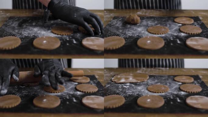 用rolling面杖将饼干面团滚动。厨师用表格做饼干。一切都在特殊的硅胶垫上完成