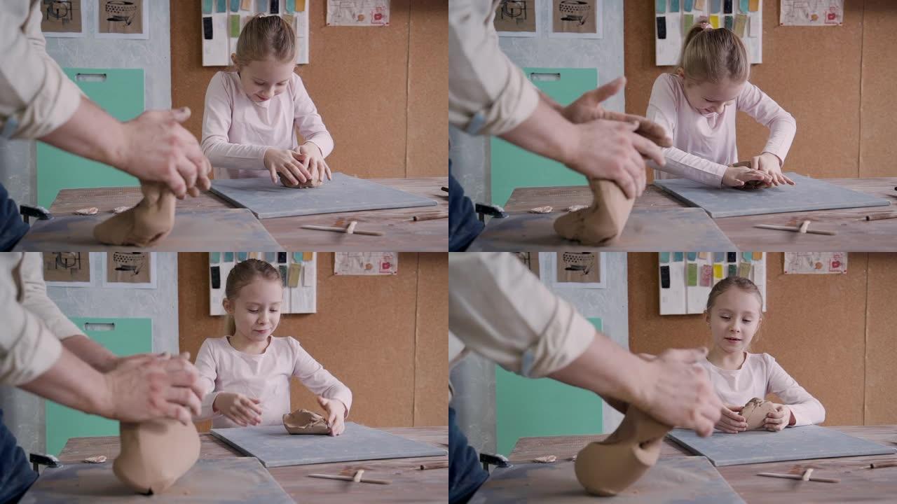 小女孩与制造大师成型粘土在小工