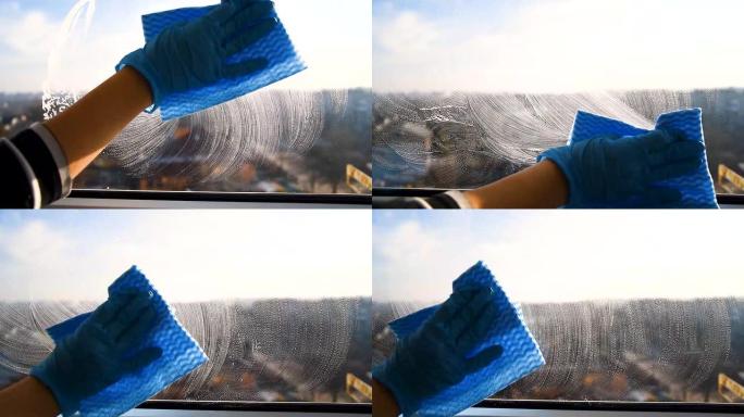 员工用微纤维布擦拭窗户免受灰尘的橡胶防护手套。，一般清洁