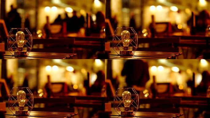 晚上户外餐厅桌子上漂亮的灯泡。风格，艺术