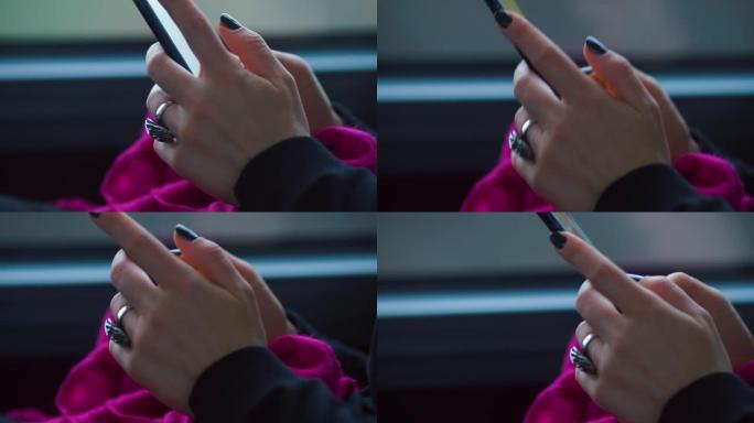 坐火车旅行的女人手中的智能手机的特写镜头。