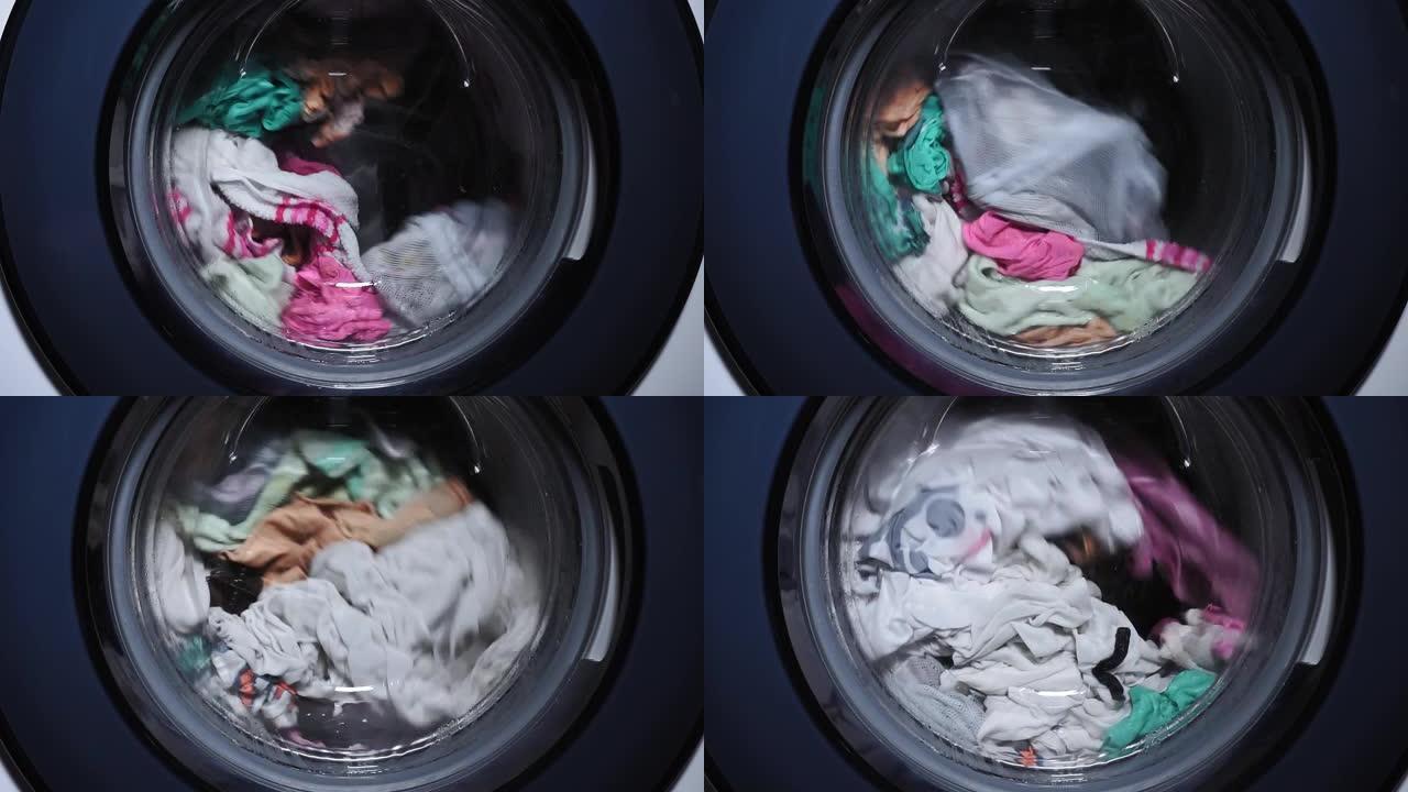 衣物在自动洗衣机中洗涤，在滚筒中旋转。洗衣服。家庭作业