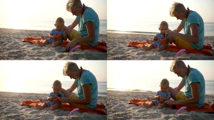 夏天的一天，小男孩和妈妈在海滩上玩耍