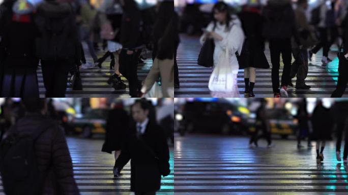 晚上在新宿东京下雨天在十字路口散步的人