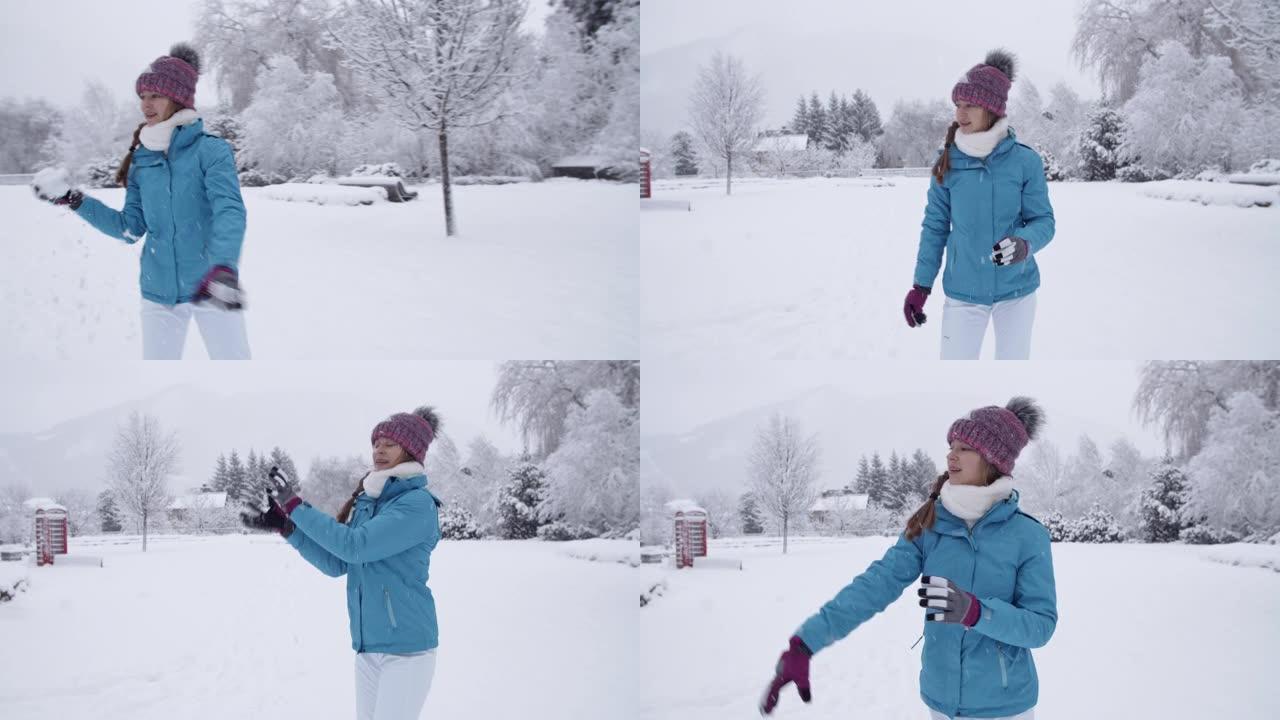Teenage girl having snowball fight