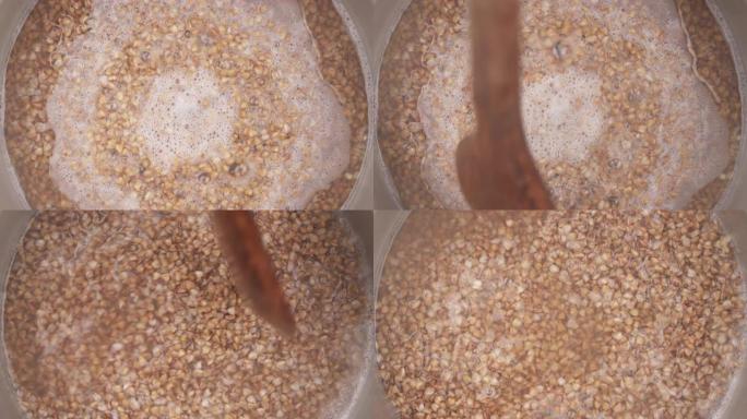 在锅中煮沸的荞麦种子的俯视图。烹饪食物概念