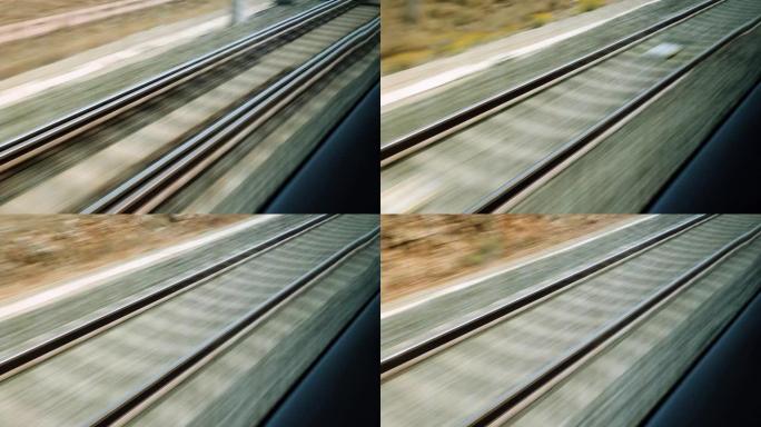 从快速列车的窗口查看铁轨。子弹头列车在铁路轨道上行驶。4K