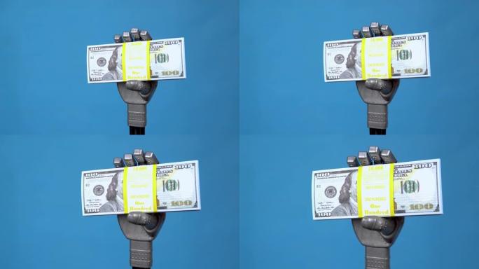 一只机械手拿着一包美元。灰色的半机械手在蓝色背景上拿着钱。4k