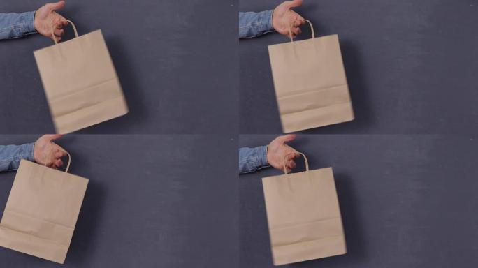 空白工艺纸购物袋模型，站在男人的手中，时尚广告，孤立的背景