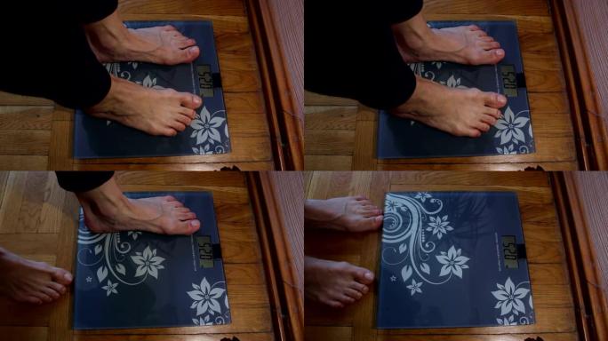 一个年轻的女孩站在秤上检查她的体重。一个年轻女孩正在家里称体重。