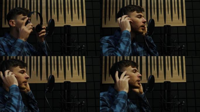 头戴式耳机的音乐家在录音棚里对着麦克风唱歌。在home sound studio录制歌曲的专业男歌手