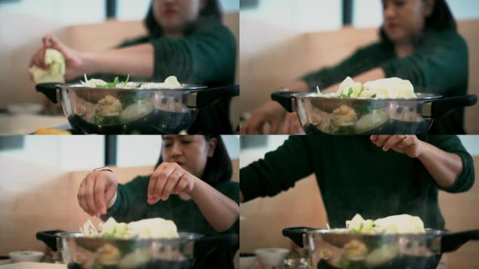 一个在餐馆吃沙锅的女人