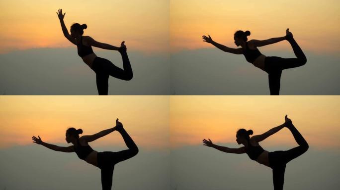 4k 60fps。亚洲年轻迷人的女人在日落山上练习瑜伽。放松并集中精力于大自然。女人的手在冥想，荷花