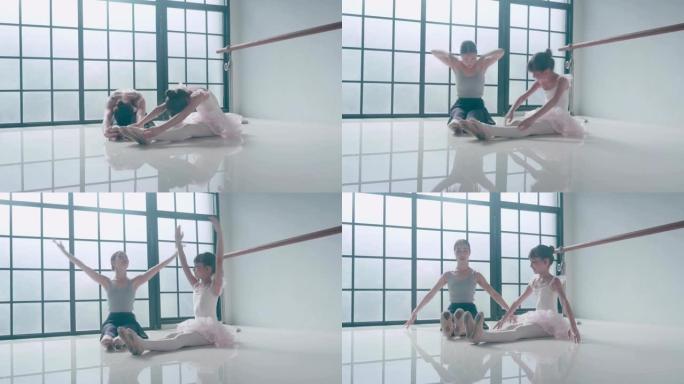 两个芭蕾舞女演员伸展腿