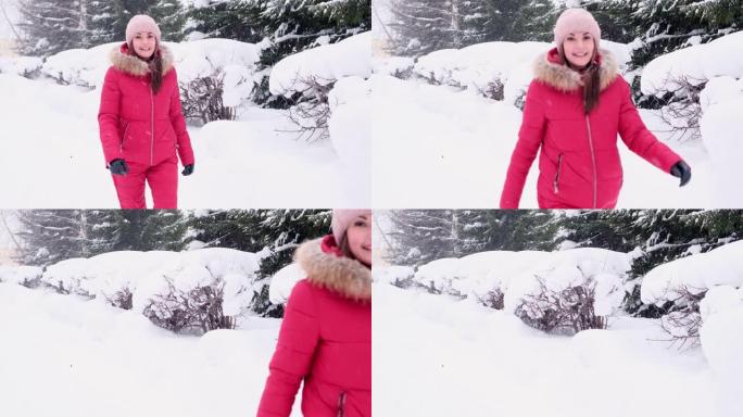 穿着红色西装的开朗年轻女子走在冬天的森林里，飘着雪。