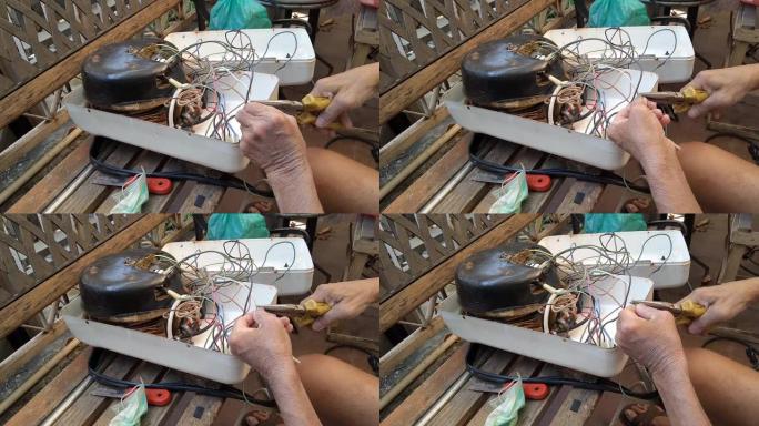 技术员修理破损的蒸汽熨斗的镜头