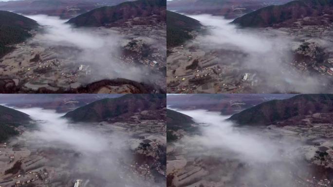 雾中的山之间村庄的航拍视频4k股票视频
