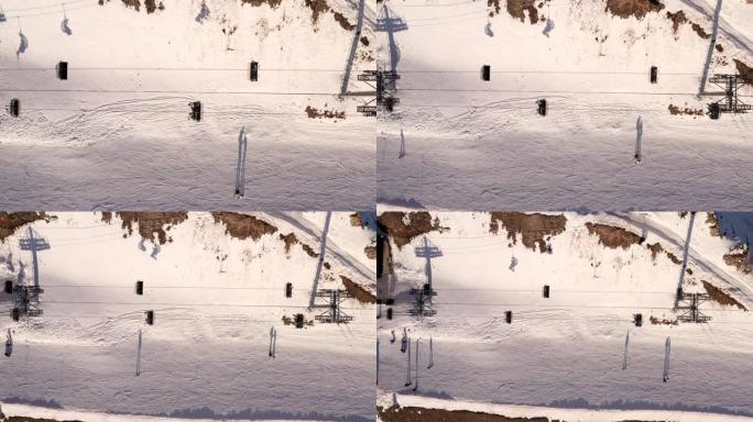 无人机滑雪电梯在避暑山庄上的俯视图。鸟瞰滑雪缆车将滑雪者和滑雪者运送到冬季度假胜地的雪坡。冬季运动和