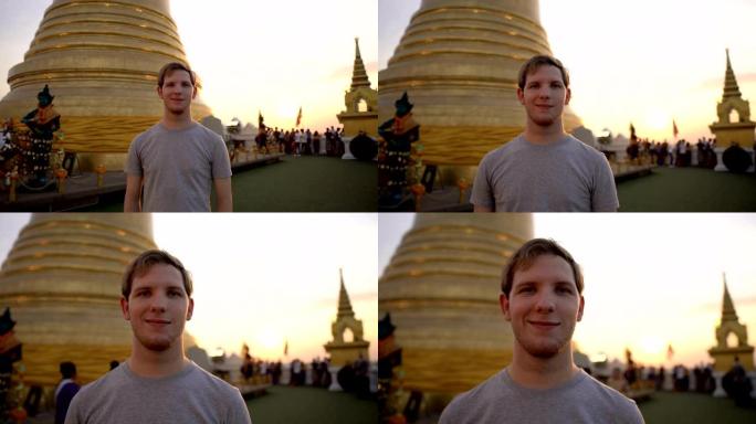 年轻旅行者的肖像与佛教寺庙和佛塔的背景
