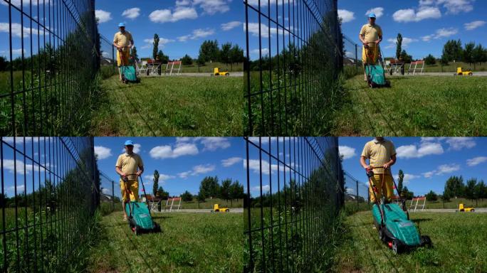 用电动割草机修剪后院草坪。万向节运动射击。