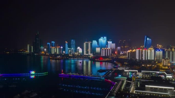 夜间照明显示青岛市市中心奥林匹克湾空中延时全景4k中国