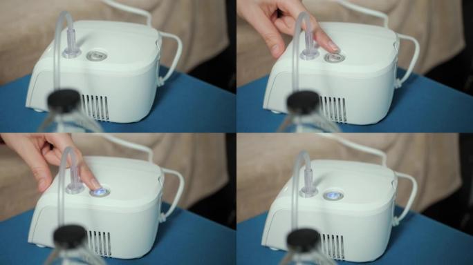 女性手指按下喷雾器上的电源按钮进行吸入。按钮开始闪烁蓝色。慢动作和特写