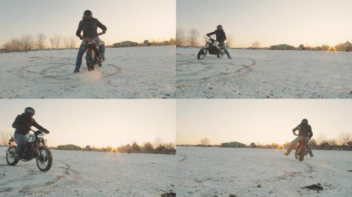 摩托车手在雪地里做轮胎倦怠，慢动作。专业摩托车手在日落时在雪地上漂移并打开摩托车。骑自行车的人在摩托