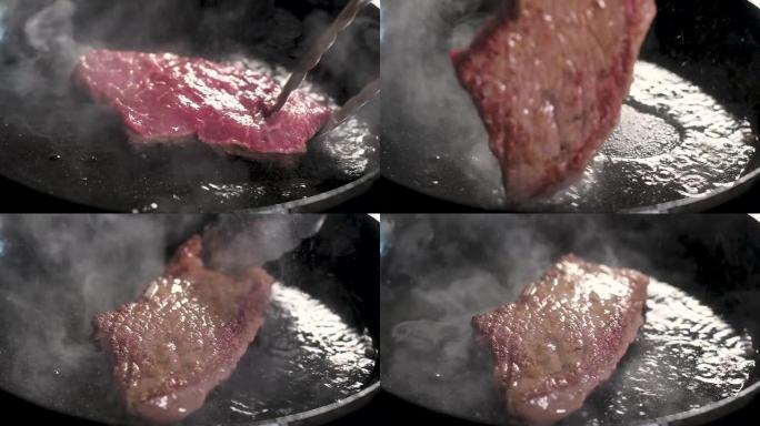 厨师钳子转动牛排。在热锅上油炸的apetite，配以一层肉。天然牛排的制备。橄榄油溅到锅上。特写，慢