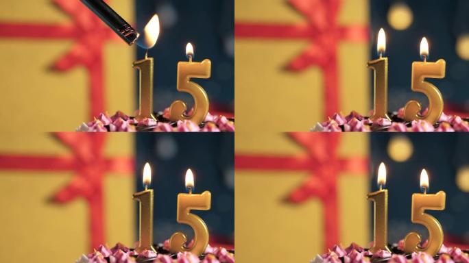 生日蛋糕15号点火器燃烧的金色蜡烛，蓝色背景礼物黄色盒子用红丝带绑起来。特写和慢动作