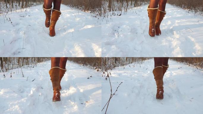 腿部女人冬季棕色皮靴和连裤袜在冬季公园的雪地上行走。暖靴特写外底