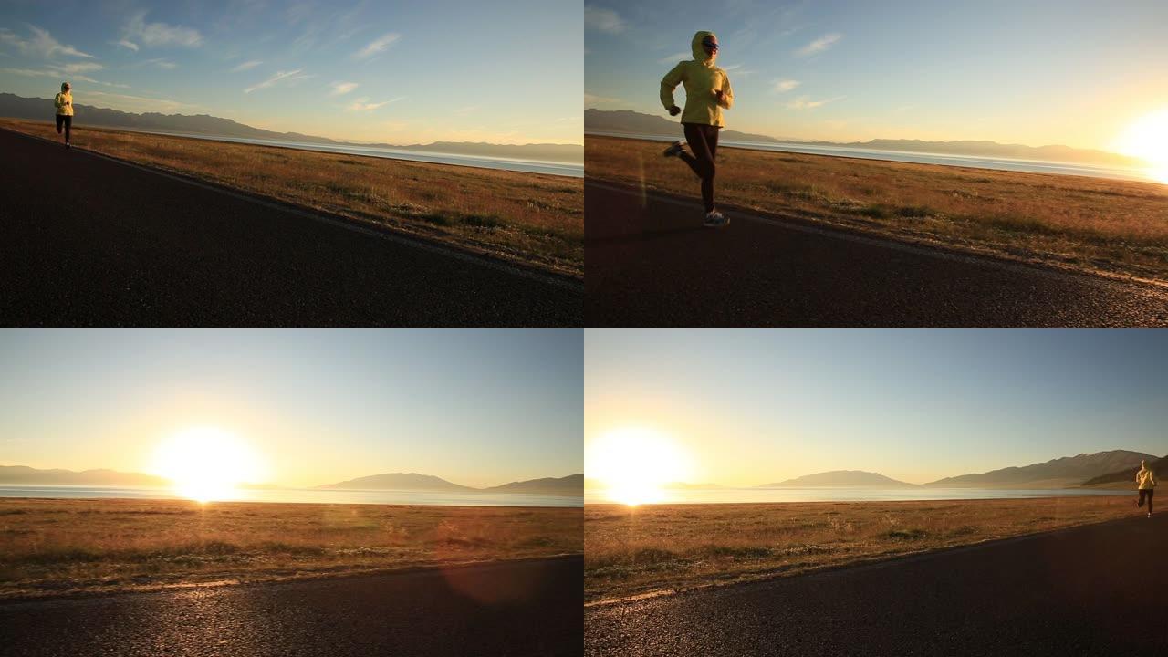 年轻的健身女跑步者在日出高海拔海滨小径上奔跑