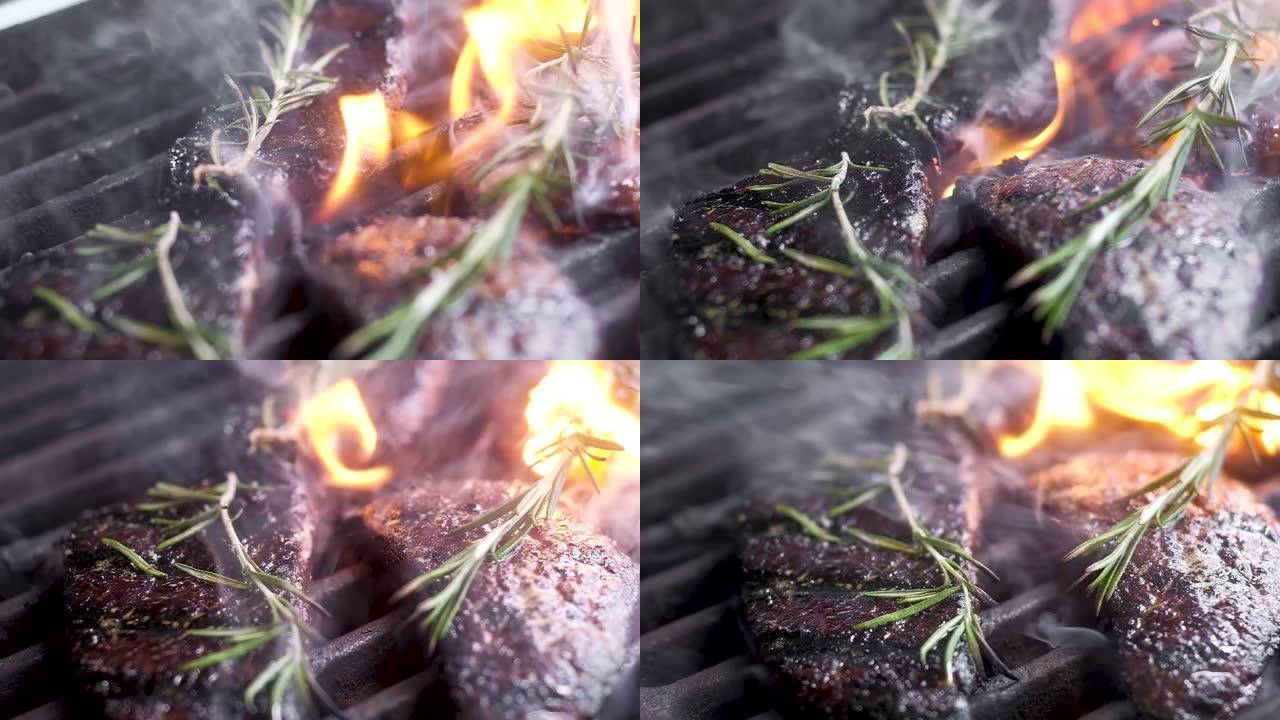 大理石牛排。用高温油炸。框架中的火焰和烟雾。周末烧烤。肉是香的百里香。相机移动，改变焦点。特写，慢动