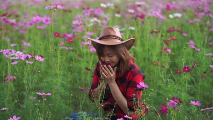 亚洲成熟女性在宇宙草地上的面部表情，手在花上奔跑