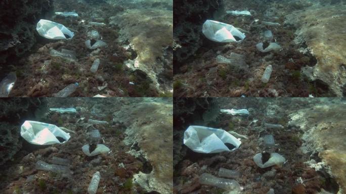 海洋底部的大量塑料污染，热带鱼游过底部，上面覆盖着大量塑料垃圾。地中海海底的瓶子、袋子和其他塑料碎片