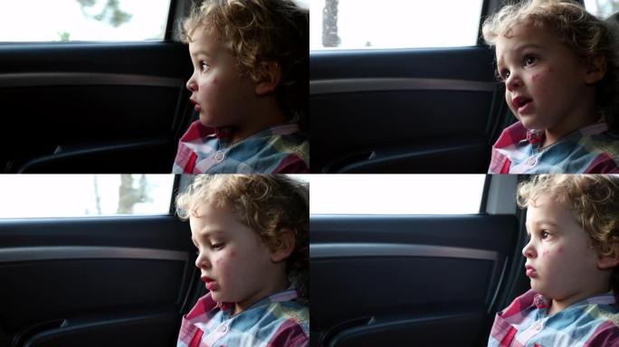 乘客孩子坐在汽车后座上，看着窗外