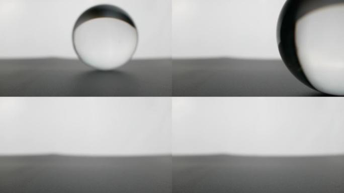 水晶玻璃球透明滚动在灰色渐变背景。