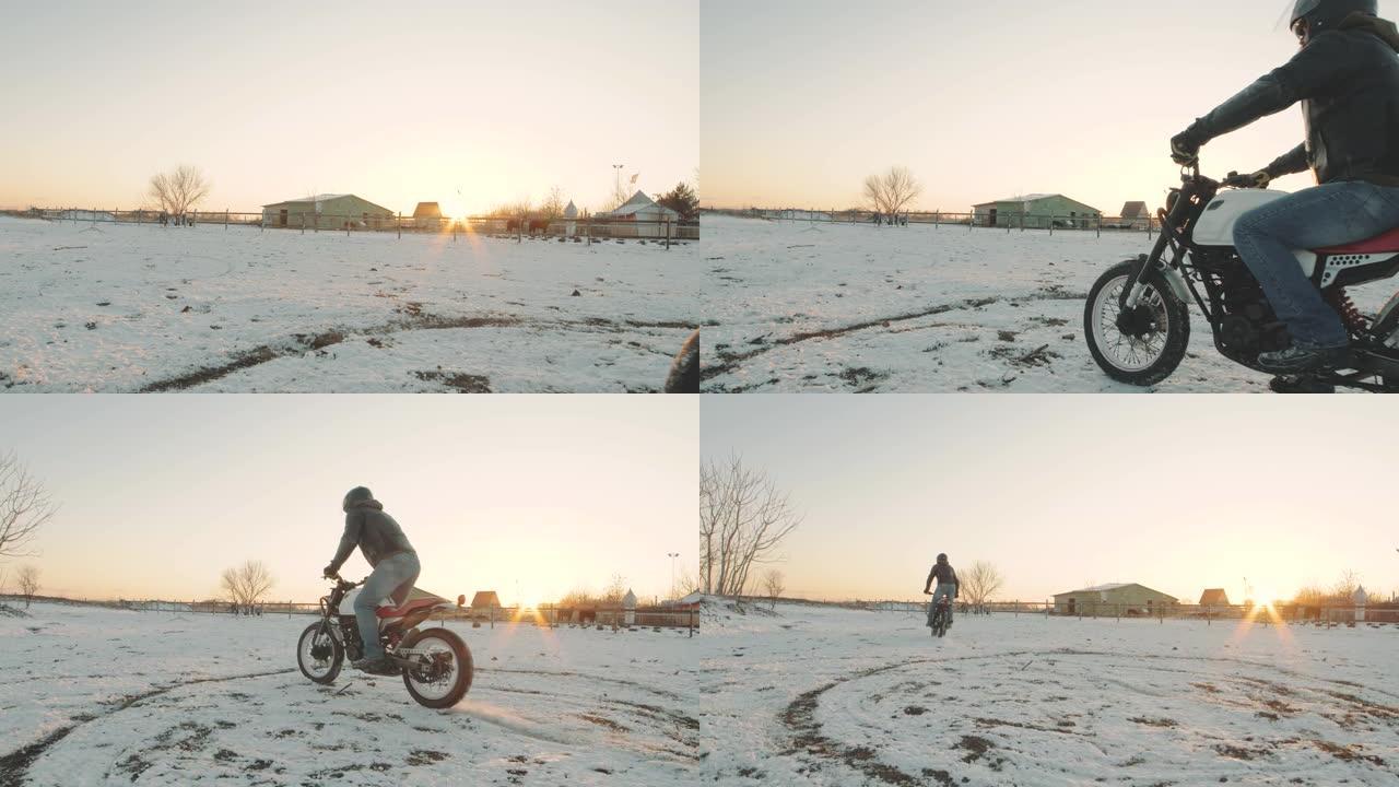 摩托车手在雪地里做轮胎倦怠，慢动作。专业摩托车手在日落时在雪地上漂移并打开摩托车。骑自行车的人在摩托