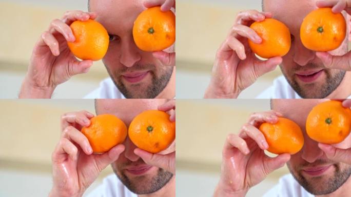 男子手持两半橘子在眼前