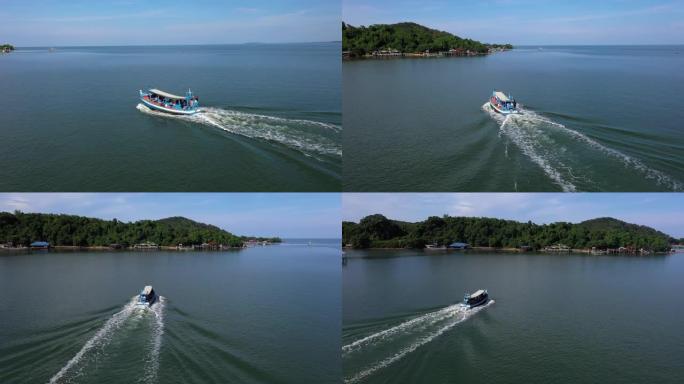 暑假期间，无人机乘船在美丽的热带绿松石海上飞行，前往岛屿