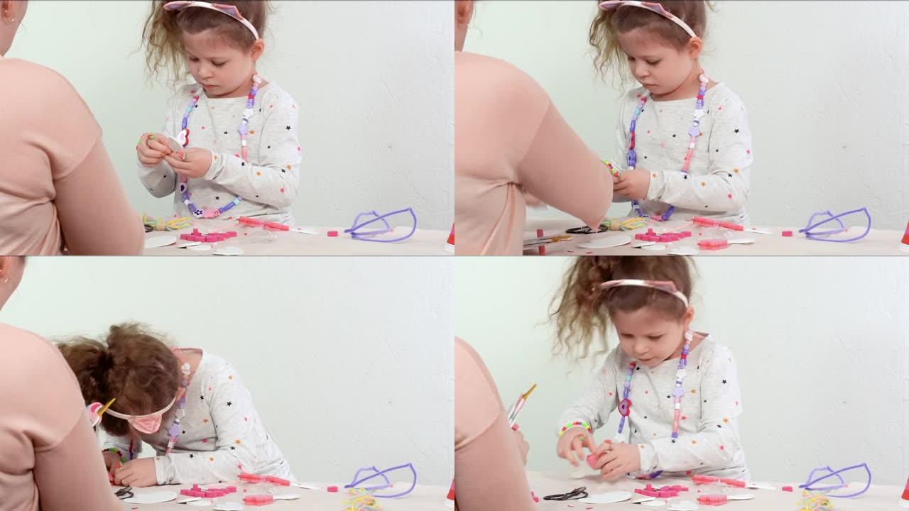 小女孩用白色和粉红色的纸泡沫制作独角兽工艺。