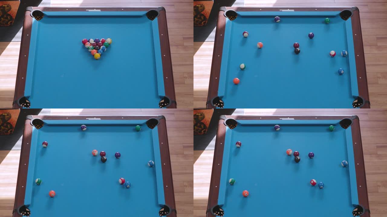 在蓝色台球桌上打破在八球形成的台球的架空视图