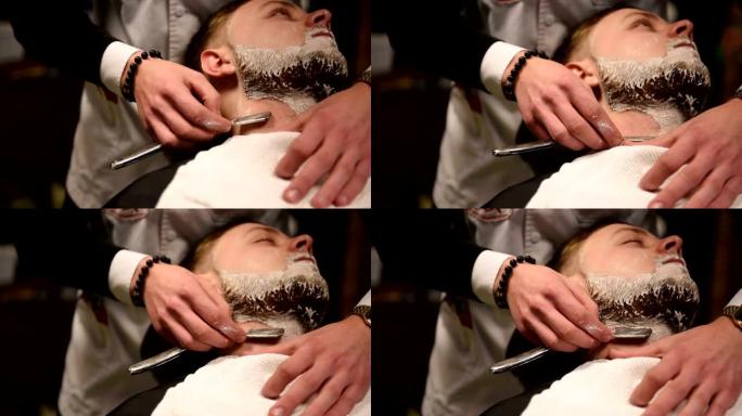 理发店或发廊的男士发型和理发。梳理胡须。理发店。男士美发师在男士发廊理发胡须成年男士。工作场所的理发