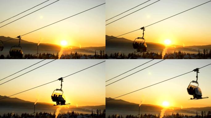 剪影滑雪者在日出时在升降椅上攀爬