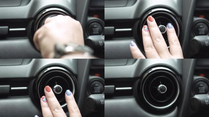 特写: 控制台上的女性手动控制汽车空调系统网格面板