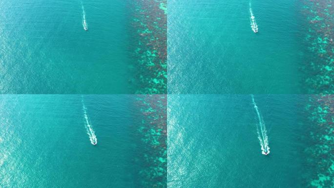 泰国沙滩上漂浮在水晶水上的长尾船的鸟瞰图。4k中的夏季鸟瞰图。