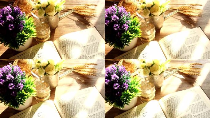 木桌上的延时书籍和鲜花，光线柔和